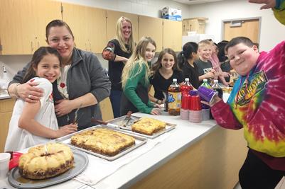 Serving international foods at DLC activity night 